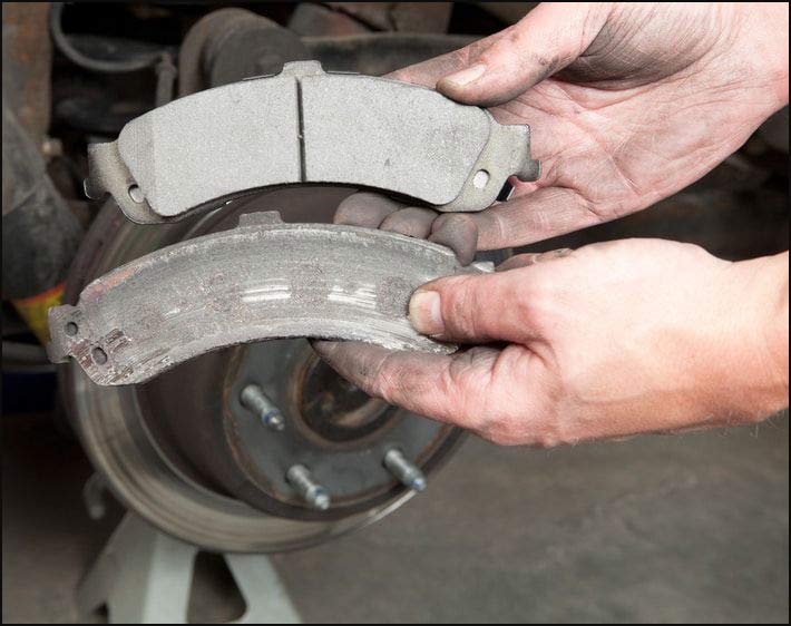 Comparison of worn brake pads versus new pads highlighting brake safety issues